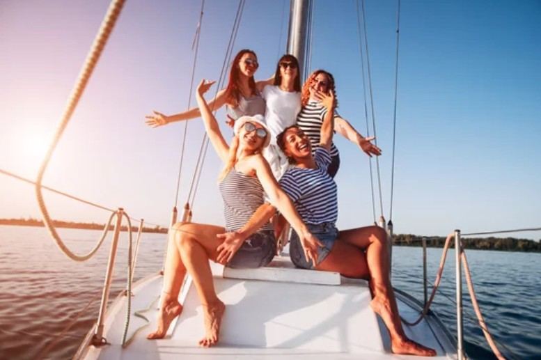 Bachelorette party on a private yacht charter with friends celebrating on the water