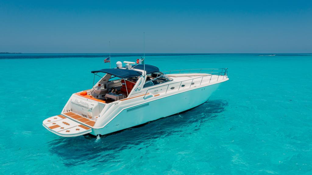 Group of friends celebrating on a private party boat in Cancún