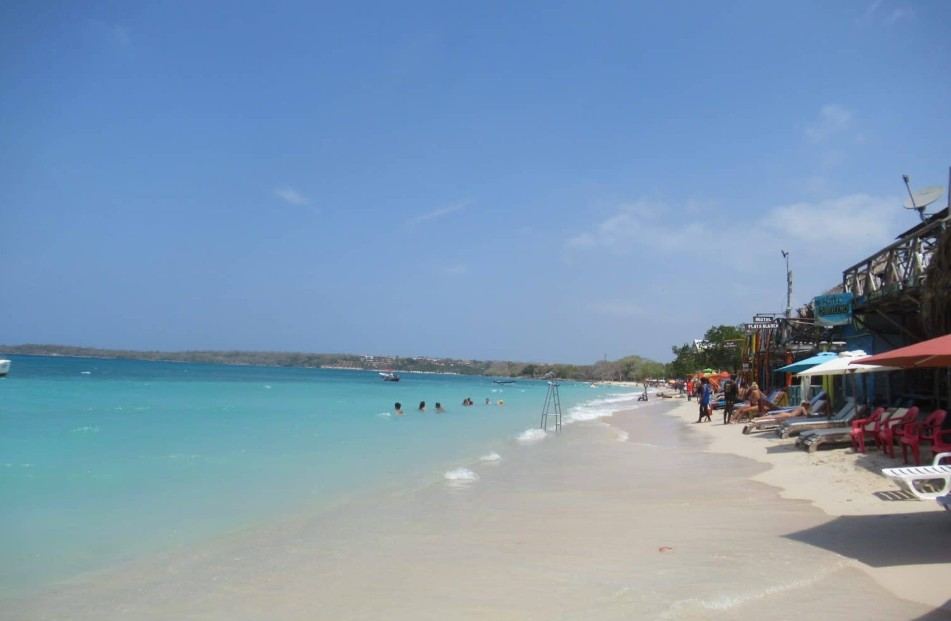 Playa Blanca Colombia white sand beach with turquoise water seen from a private boat
