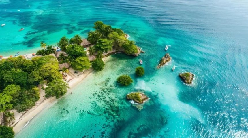 Aerial view of a Rosario Islands cay with white sand beach, palm trees and clear water